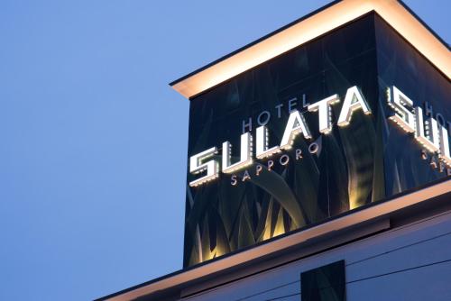 a sign on the side of a building at HOTEL SULATA Sapporo (Adult Only) in Sapporo