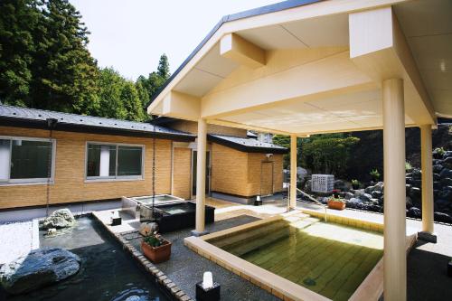 a house with a swimming pool in the backyard at Shoenso Hozugawatei in Kameoka