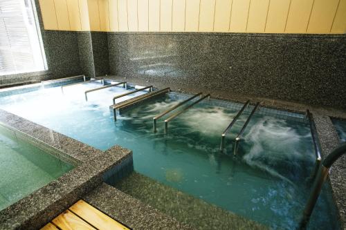 a pool of water with a row of stairs in it at Shoenso Hozugawatei in Kameoka