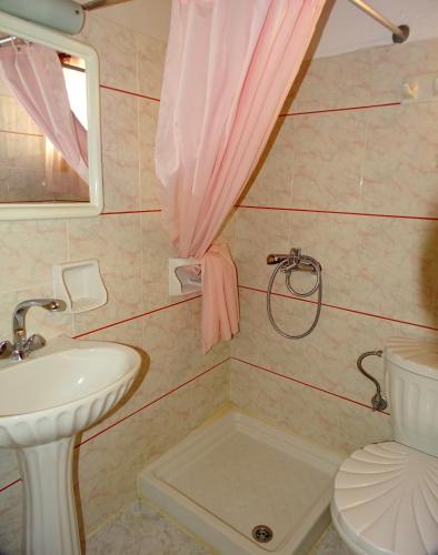 a bathroom with a sink and a toilet at Anemones Rooms in Chania