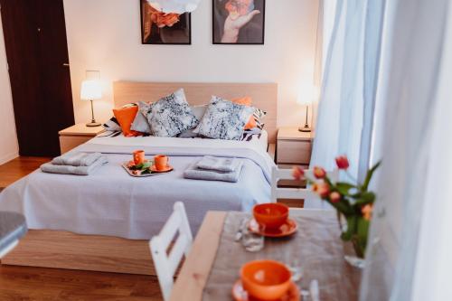 a bedroom with a bed with a tray of food on it at Garden Apartment in Kraków