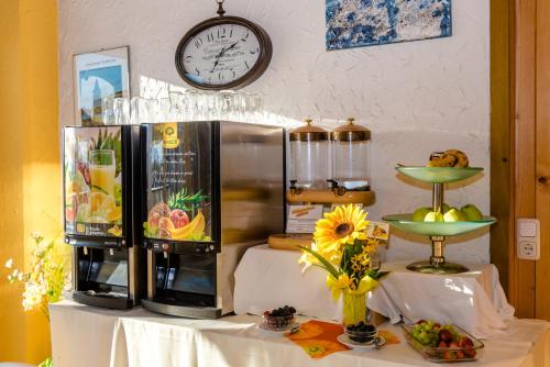 a counter with a refrigerator and a clock on a wall at Stadthotel Schwerterbräu in Judenburg