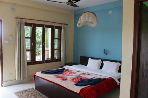 a bedroom with a large bed with blue walls at Dahachok Homestay in Dahachok