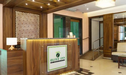 a lobby with a table and a chair in a room at Treebo Olive Inn in Mumbai