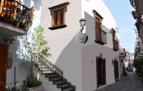 a street in a town with stairs and windows at Case Vacanze S. Anna in Lipari