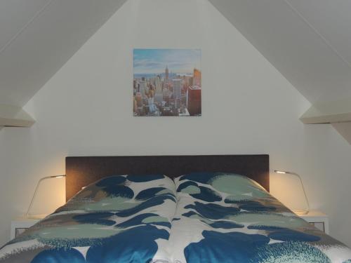 1 dormitorio con 1 cama con una pintura en la pared en Bed&Breakfast Hoornaar, en Hoornaar