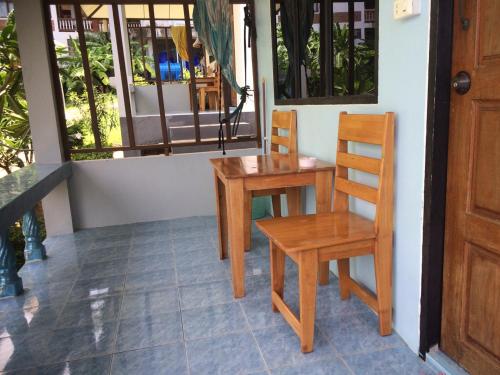 a table and chairs on the porch of a house at Light In bungalow in Haad Rin