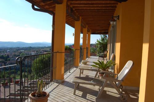 a balcony of a house with chairs on it at Villa Lucrezia in Reggello