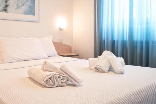 a hotel room with two towels on a bed at Residence Domaso in Domaso