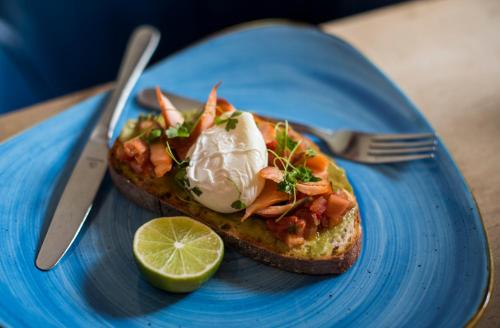 a blue plate with a piece of bread with food on it at Buccleuch Arms in Saint Boswells
