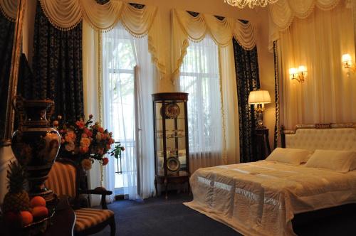 a bedroom with a bed and a large window at Queen Valery Hotel in Odesa