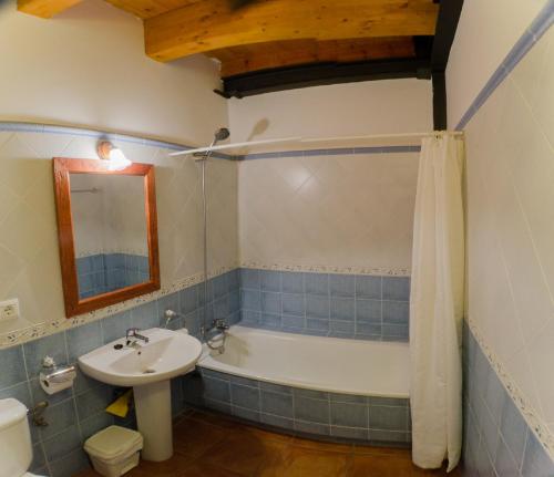 a bathroom with a sink and a bath tub at Casa El Centro in Beceite