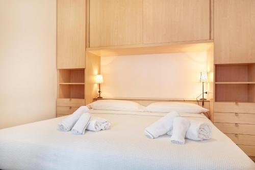 a bedroom with a white bed with two pillows at Residence Domaso in Domaso