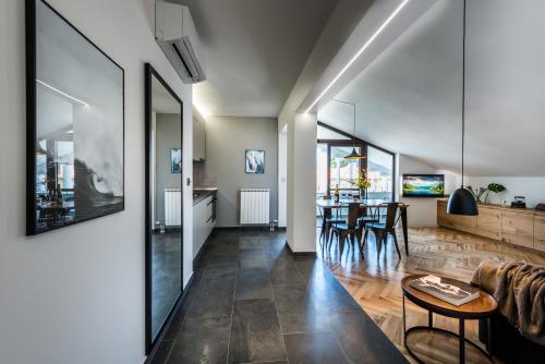 a living room and dining room with a table and chairs at The Park Apartments in Zadar