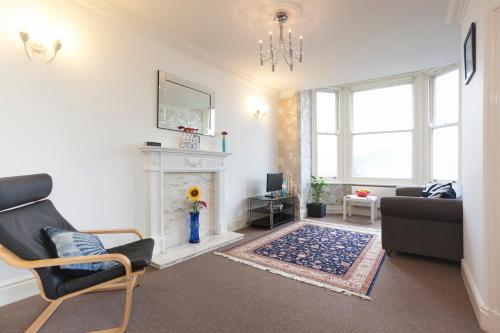 a living room with a couch and a fireplace at Magdala Apartment in Nottingham