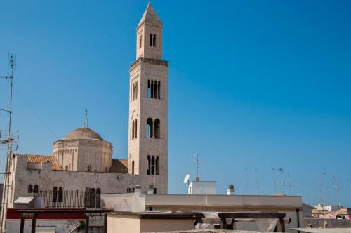 a building with a clock tower on top of it at Palazzo Verrone in Bari