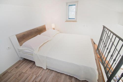 Katil atau katil-katil dalam bilik di Apartmani Daniela