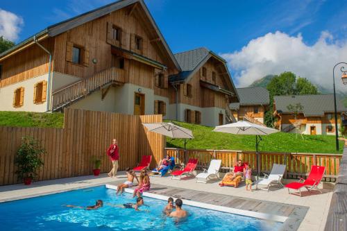 a group of people playing in a swimming pool at Goélia Les Chalets de Belledonne in Saint-Colomban-des-Villards