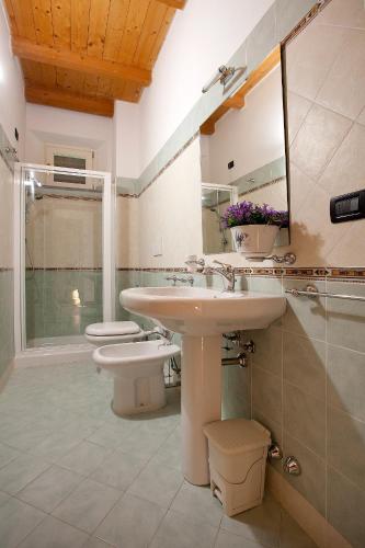 a bathroom with a sink and a toilet and a mirror at Tenuta San Giovanni Lucca in Lucca