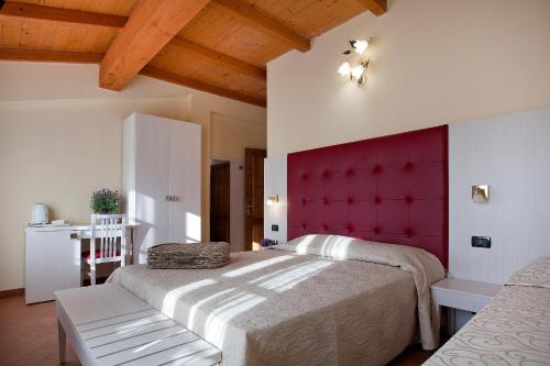 a bedroom with a large bed with a red headboard at Tenuta San Giovanni Lucca in Lucca