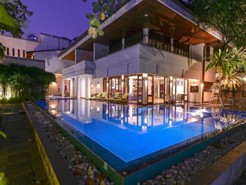 a house with a swimming pool in front of it at Colombo Court Hotel & Spa in Colombo