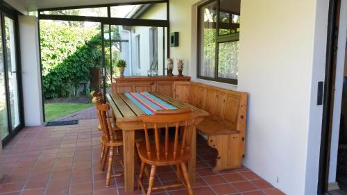 a porch with a wooden table and chairs at Lavendel Cottage in Sedgefield