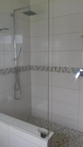 a shower with a glass door and a tub at Lavendel Cottage in Sedgefield