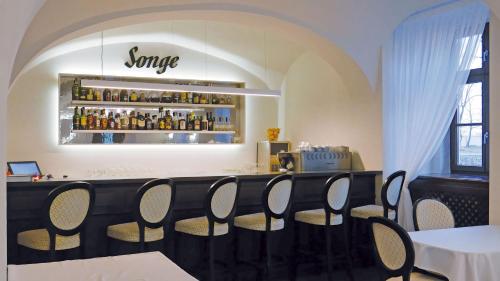 a restaurant with a bar with chairs around it at Chateau Appony in Oponice