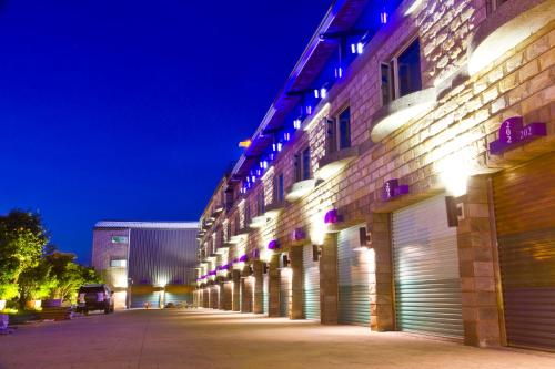 a row of garages on the side of a building at night at Yue Xin Motel in Miaoli