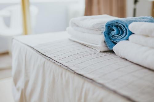 a pile of towels sitting on top of a bed at Stephanie Studios in Larnaka