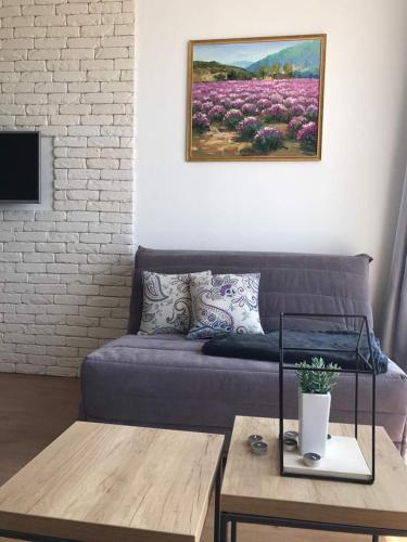 a living room with a couch and a table at VilaA21 in Bar