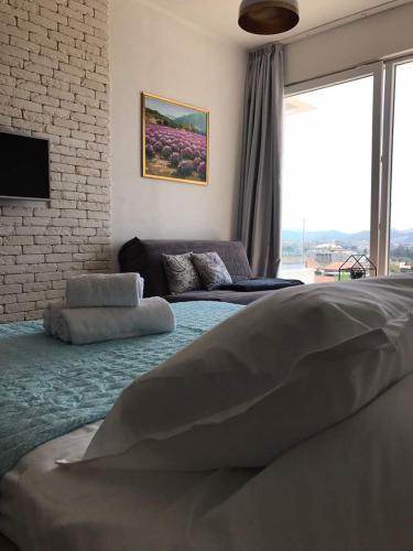 a bedroom with a large bed and a large window at VilaA21 in Bar