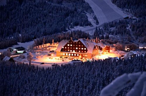 a lodge in the middle of a mountain at night at Hotel Červenohorské sedlo in Loučná nad Desnou