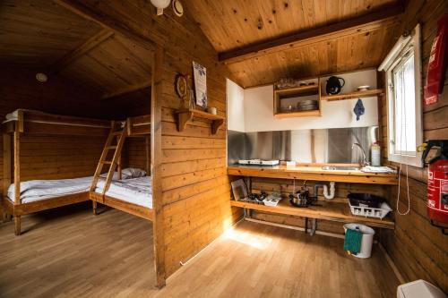 a room with two bunk beds in a cabin at Volcano Huts Þórsmörk in Thorsmork