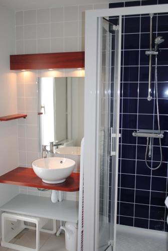 a bathroom with a sink and a shower at VVF Golfe du Morbihan Sarzeau Arzon in Sarzeau