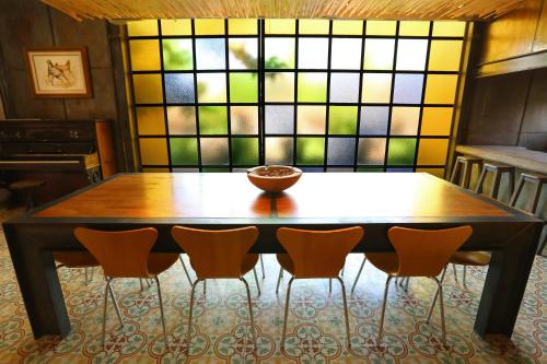a wooden table with chairs and a bowl on top at Finca Adalgisa in Chacras de Coria