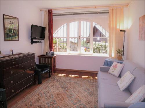 a living room with a couch and a window at Villa Margherita in Anduins