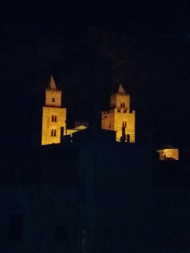 a building with two towers lit up at night at Azzurro B&B in Cefalù