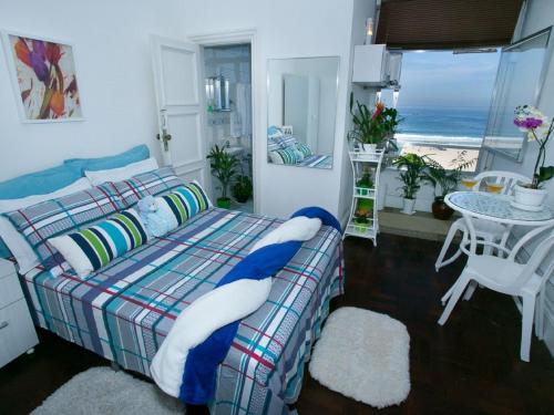 een slaapkamer met een bed en uitzicht op de oceaan bij Deslumbrante vista para a Praia de Copacabana. in Rio de Janeiro