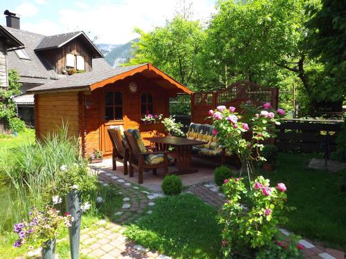 a patio with a table and chairs in a yard at Apartment Silvia Cijan in Hallstatt