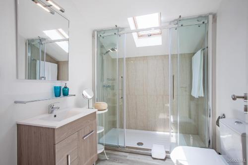 a bathroom with a glass shower and a sink at Zona Velha Apartments by An Island Apart in Funchal