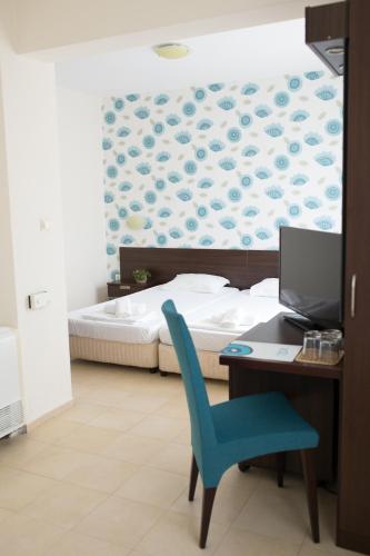 Ένα ή περισσότερα κρεβάτια σε δωμάτιο στο Ema Hotel