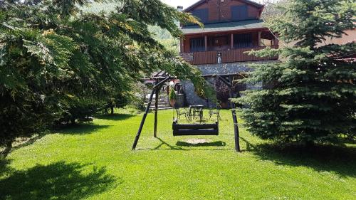 a swing in a yard in front of a house at Chalet Parea in Metamorfosi
