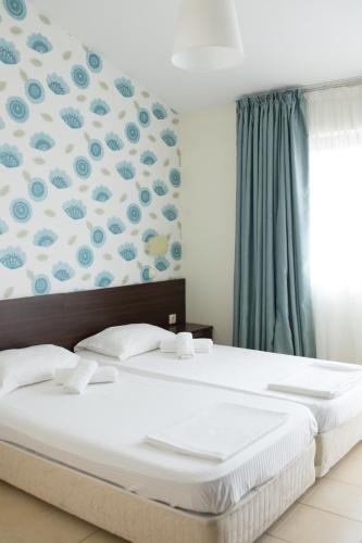 Ένα ή περισσότερα κρεβάτια σε δωμάτιο στο Ema Hotel