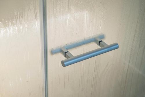 a blue door handle on a glass door at SeaPark Hotel Wellness & Spa in Kołobrzeg