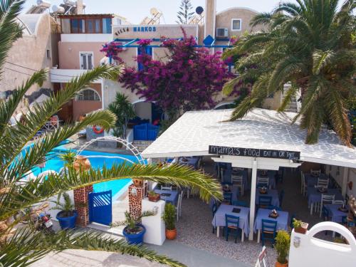 an overhead view of a hotel with a pool and palm trees at Villa Markos in Perissa