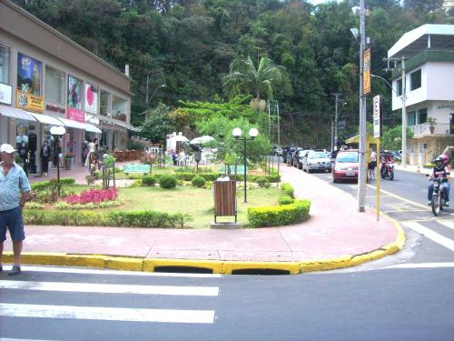 a man standing on a street corner in a city at Hotel Moinho de Pedra in Serra Negra