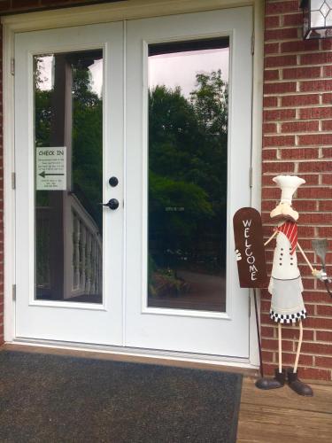 a door to a house with a sign next to it at Grafton Lodge in Lake Lure