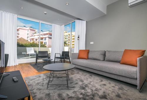 a living room with a couch and a table at Apartamentos Turisticos Paraiso in Funchal