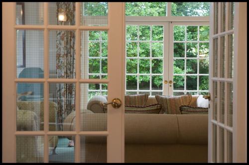 a living room with a couch through a door at Greywalls Hotel & Chez Roux in Gullane